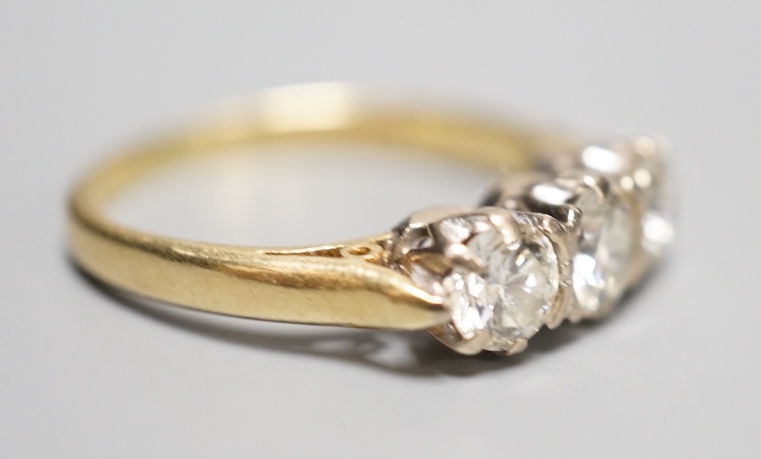 A modern 18ct gold and three stone diamond ring, size L, gross weight 3.3 grams